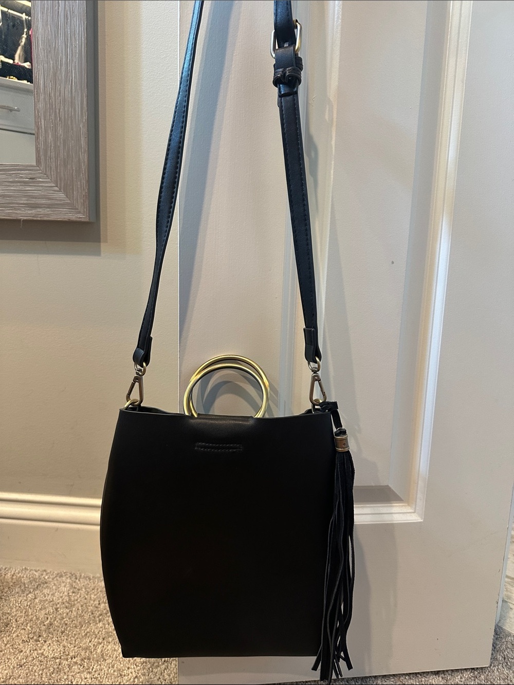 Elegant Black Crossbody Bag with Gold Ring Handles and Tassel